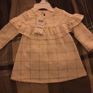 A white long sleeved dress.